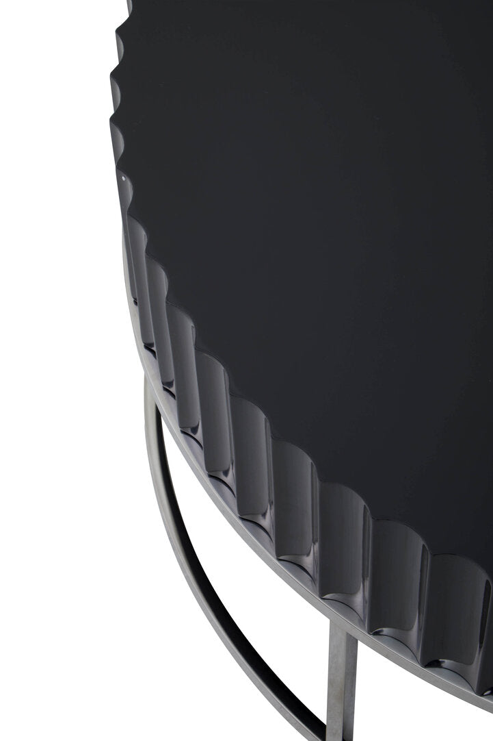 "Detail of Round Black coffee table on stainless steel  base on white background"