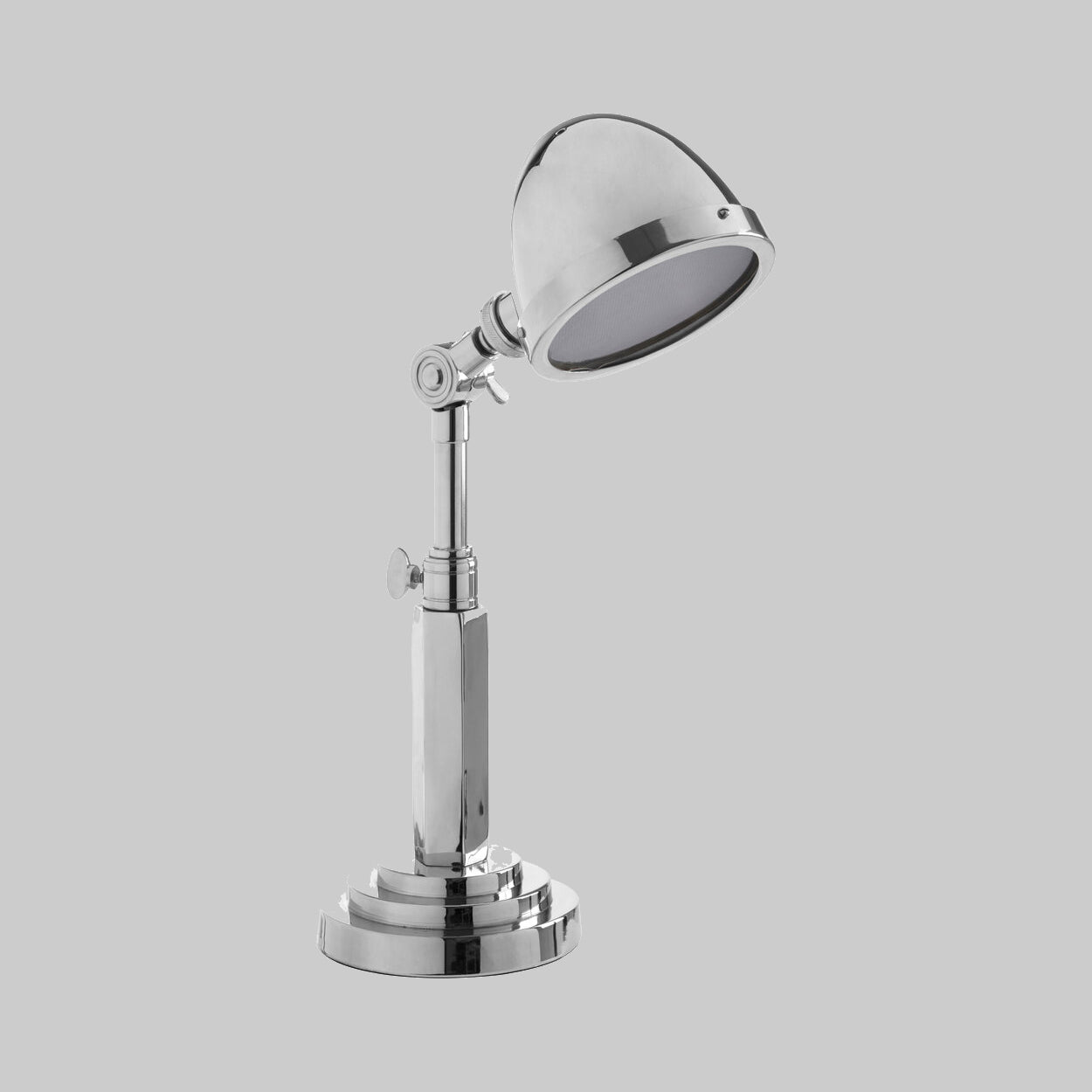 "Chrome desk lamp on a gray background"
