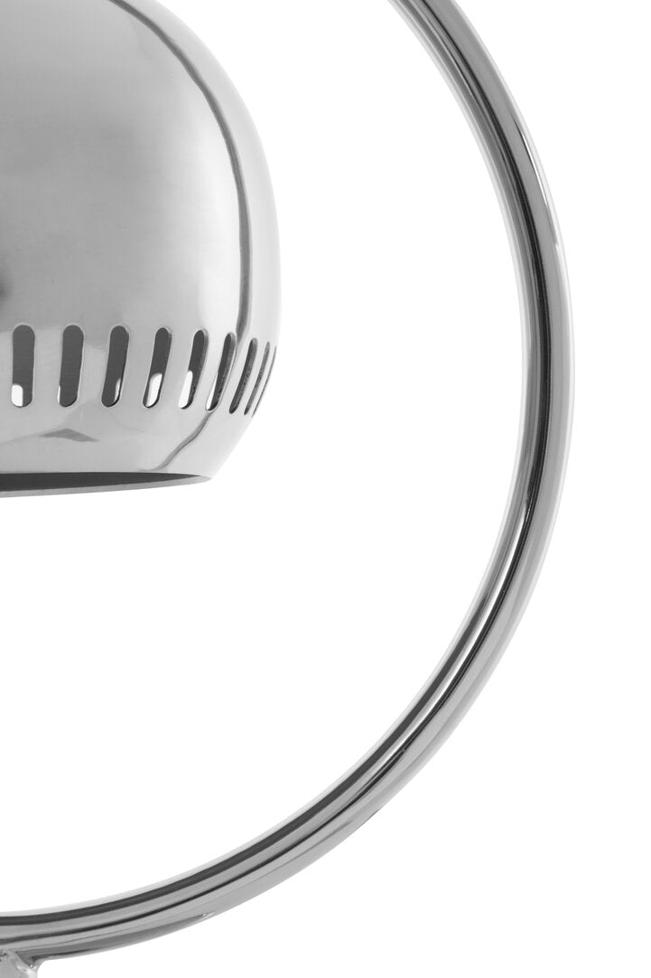 "Close-up of a metallic lamp shade with circular design on a white background"