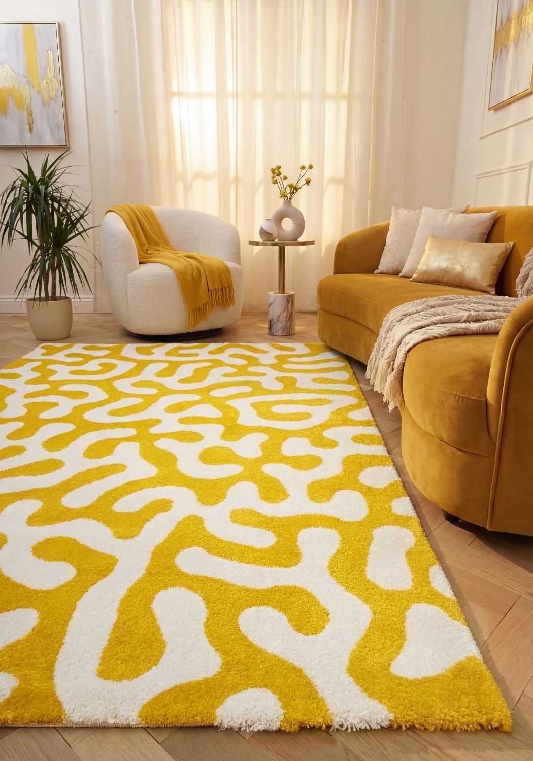 Living room with a yellow and white patterned rug, mustard sofa, and white armchair.