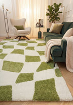 Living room with a green and white checkered rug, green sofa, and armchair.