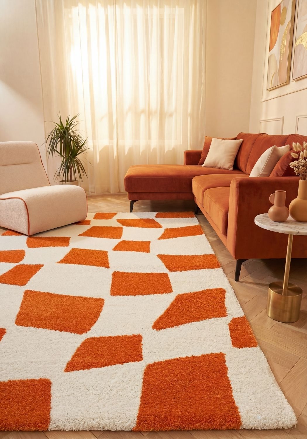 Living room with orange and white geometric rug, orange sofa, and beige walls.