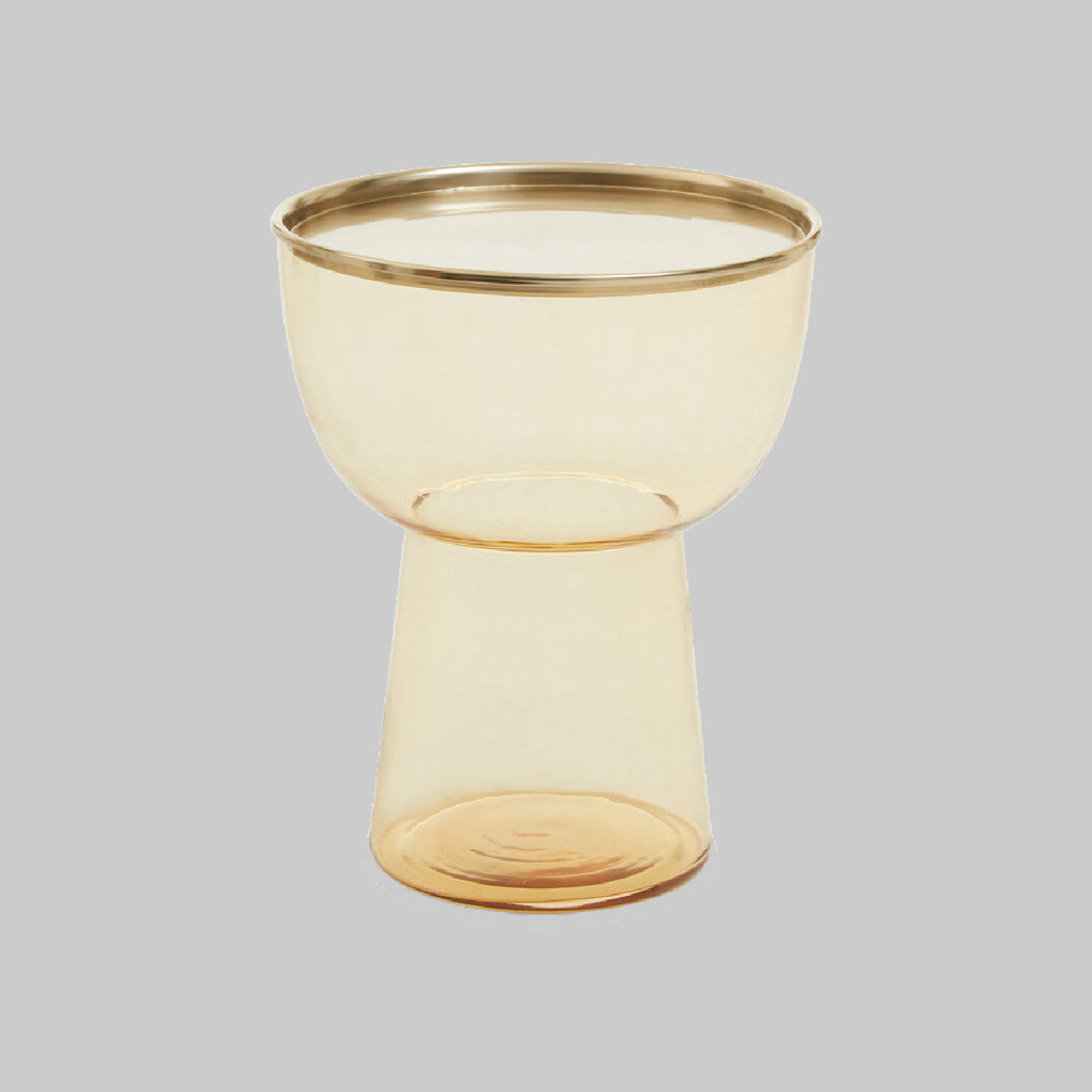 Amber glass side table on grey background