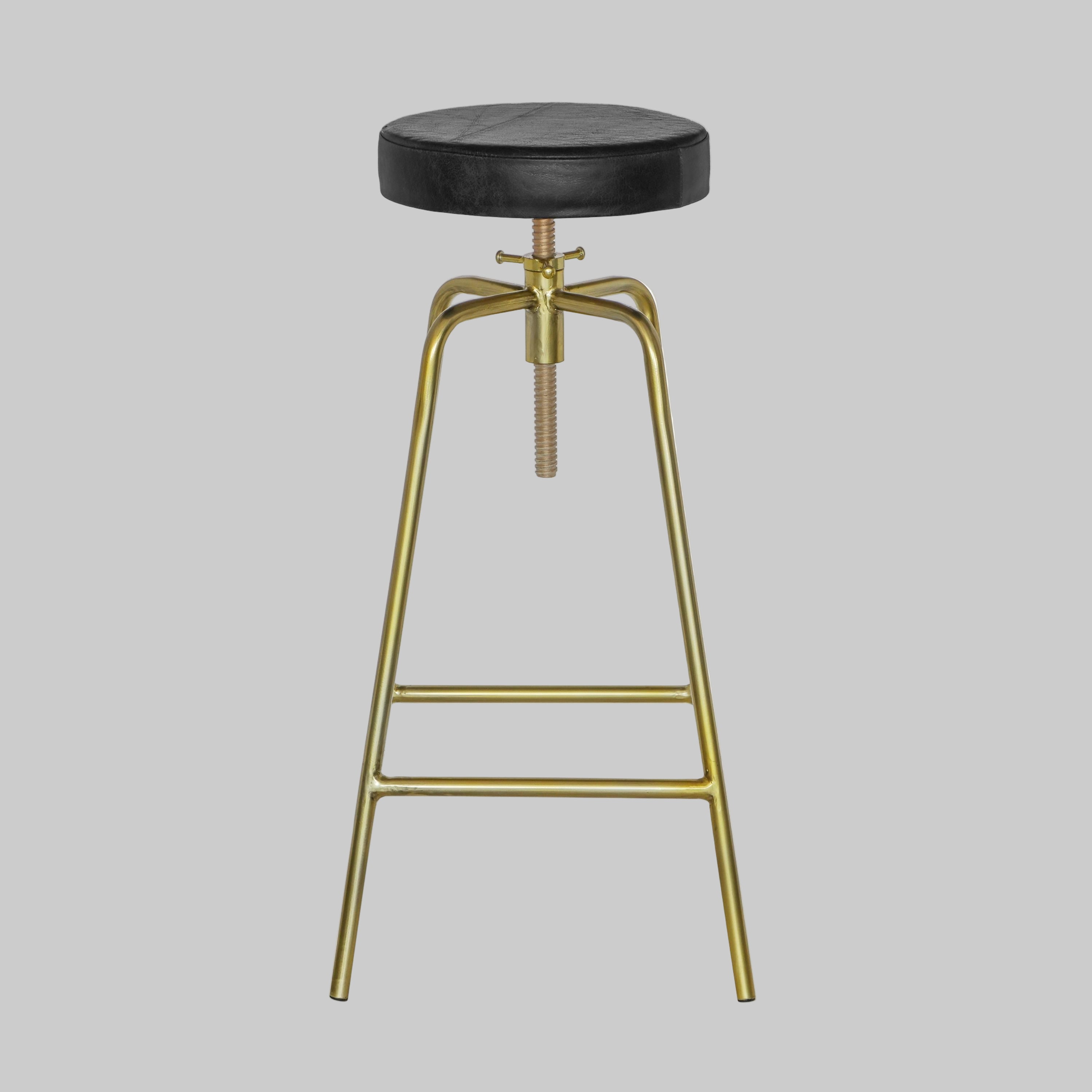 Bar stool with black seat and gold metal frame on a white background