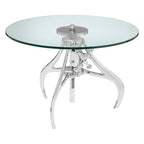 Glass round table with chrome metal base on a white background