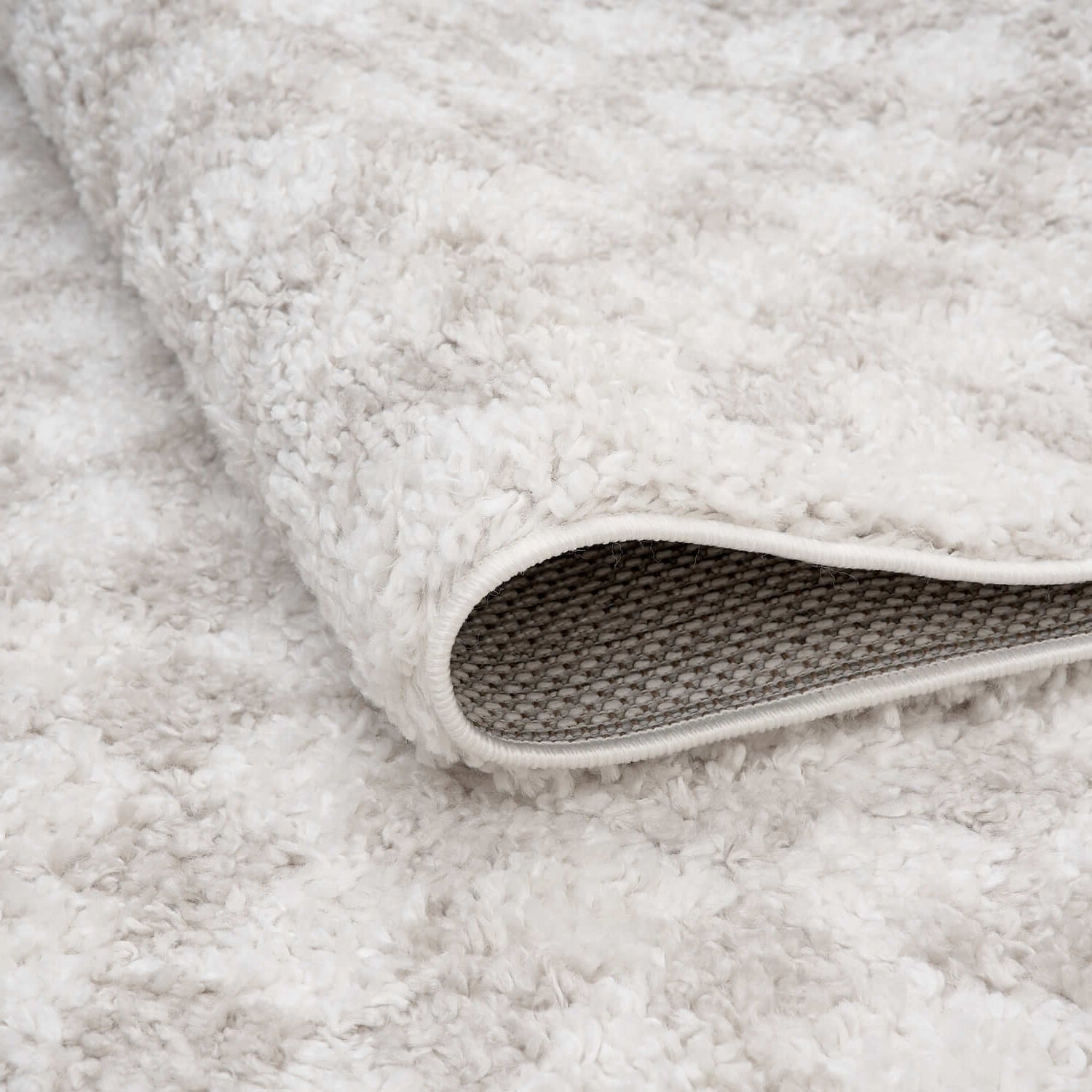 Close-up of a textured gray rug with a visible border.