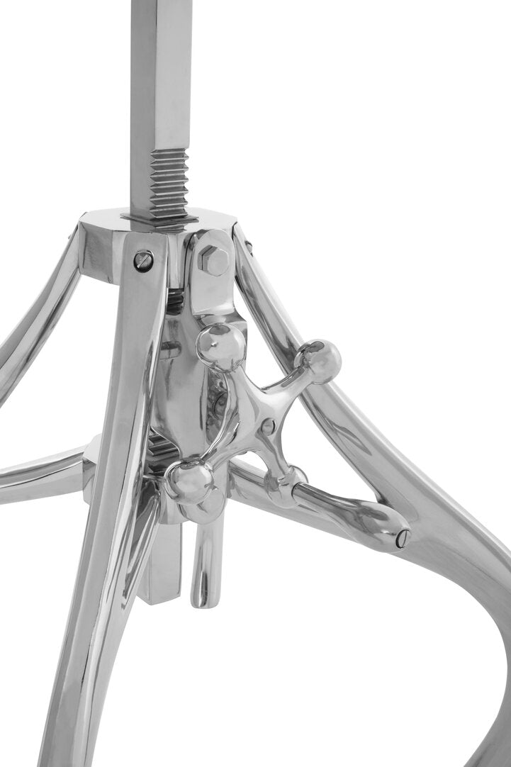 Close-up of a silver crank stand on a white background