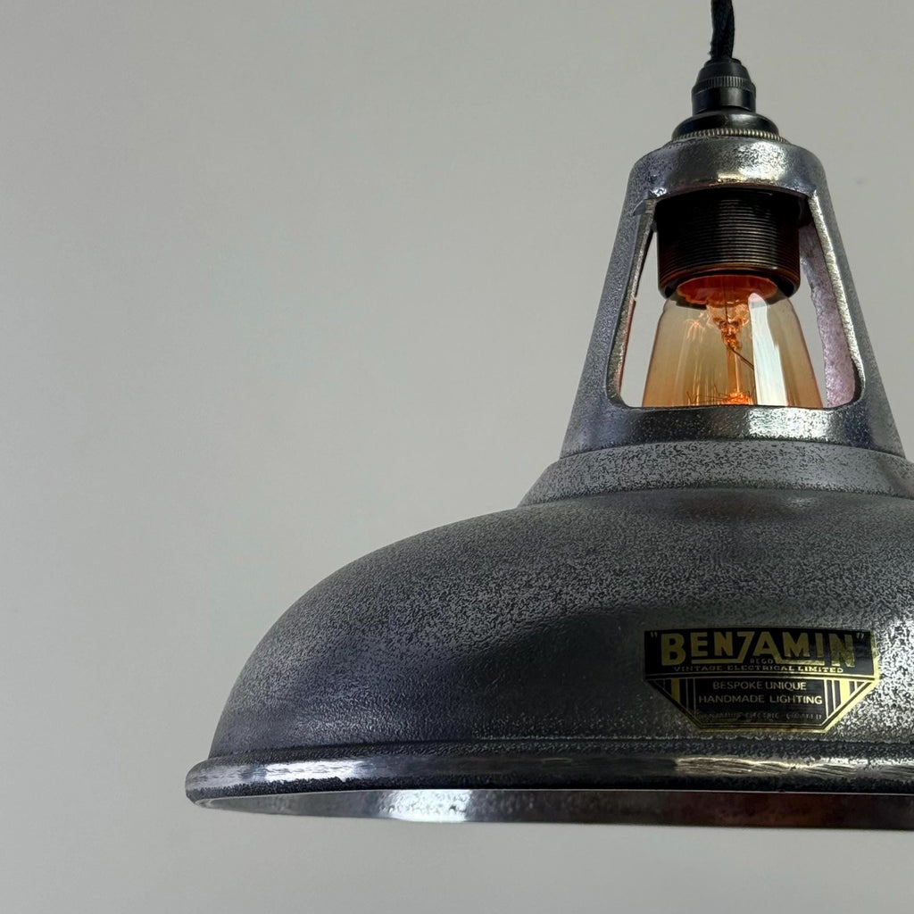 Vintage-style pendant light with a Benjamin Lighting label on a gray background