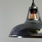 Vintage-style pendant light with a Benjamin Lighting label on a gray background