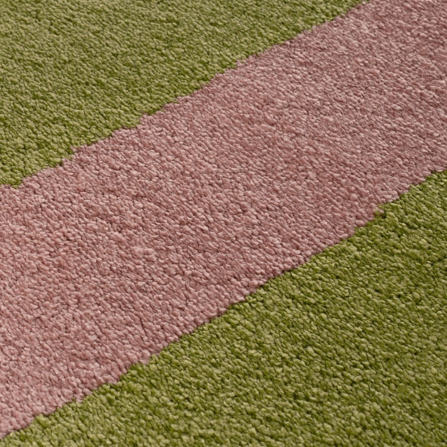 Close-up of a textured surface with alternating pink and green stripes