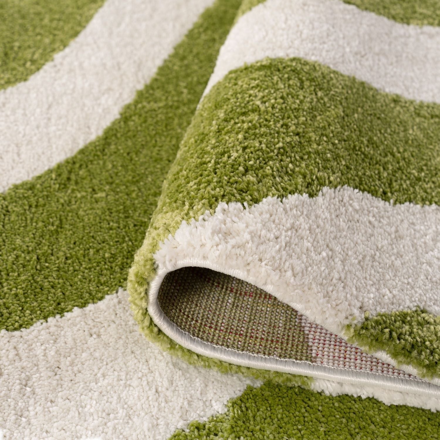 Close-up of a green and white patterned rug