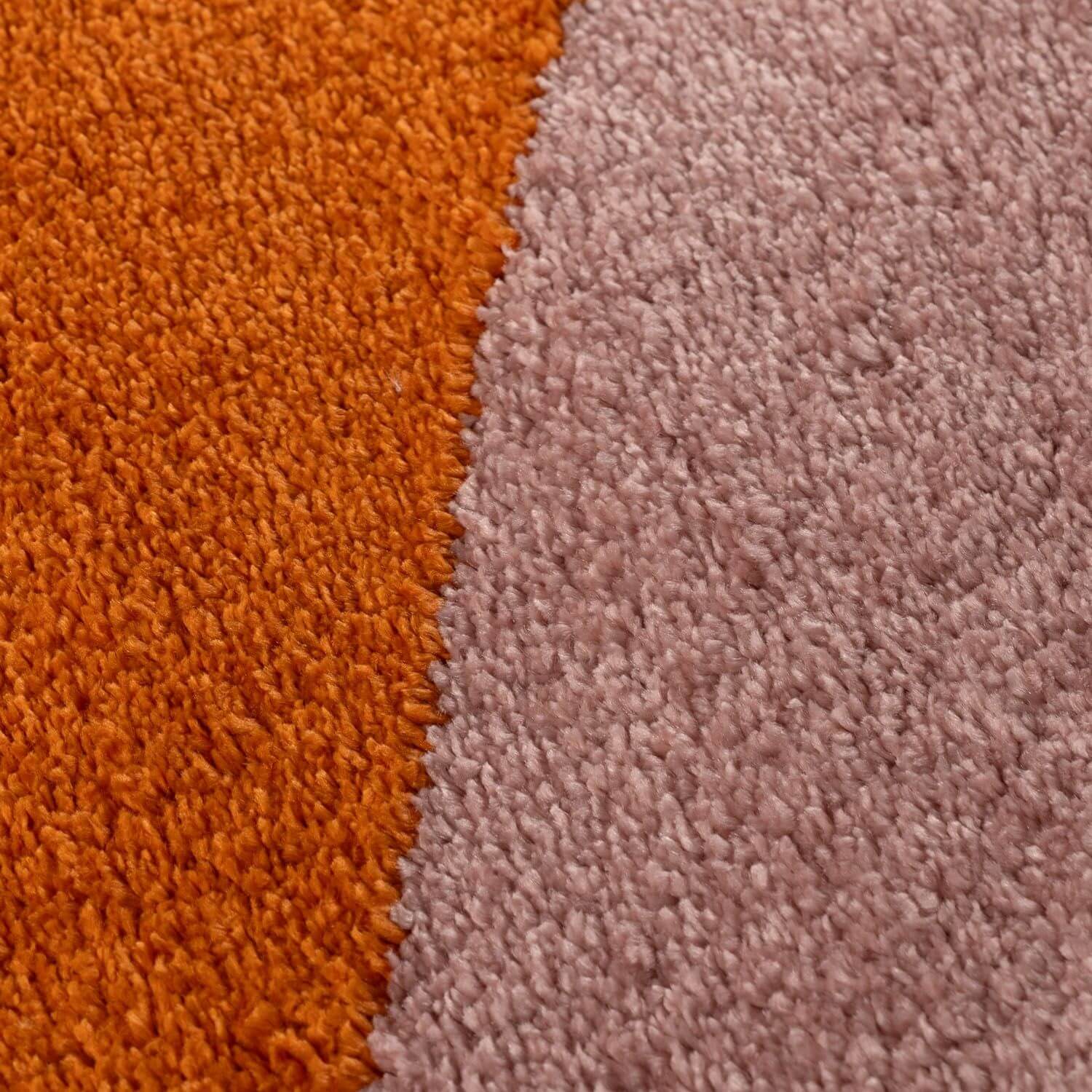 Close-up of orange and pink textured carpet