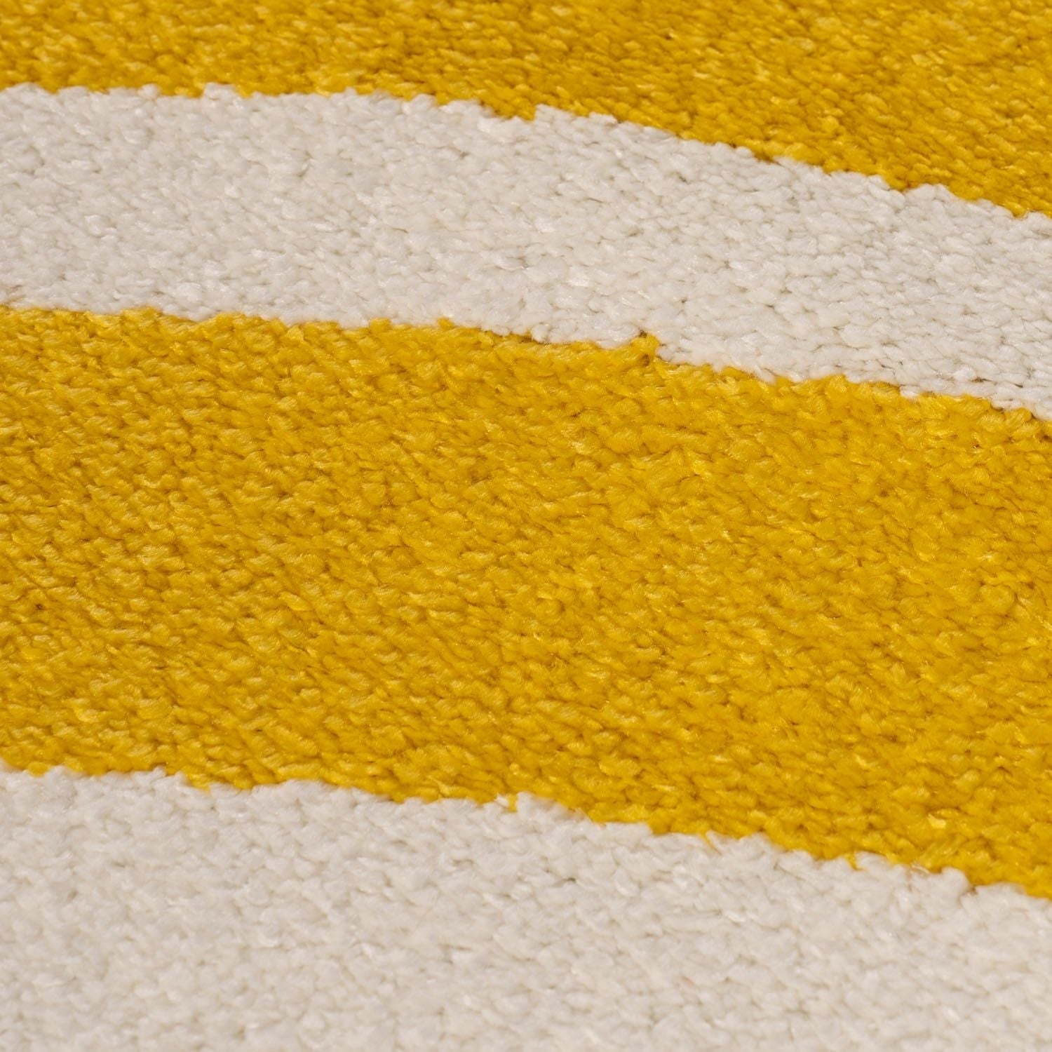 Close-up of a textured surface with yellow and white stripes