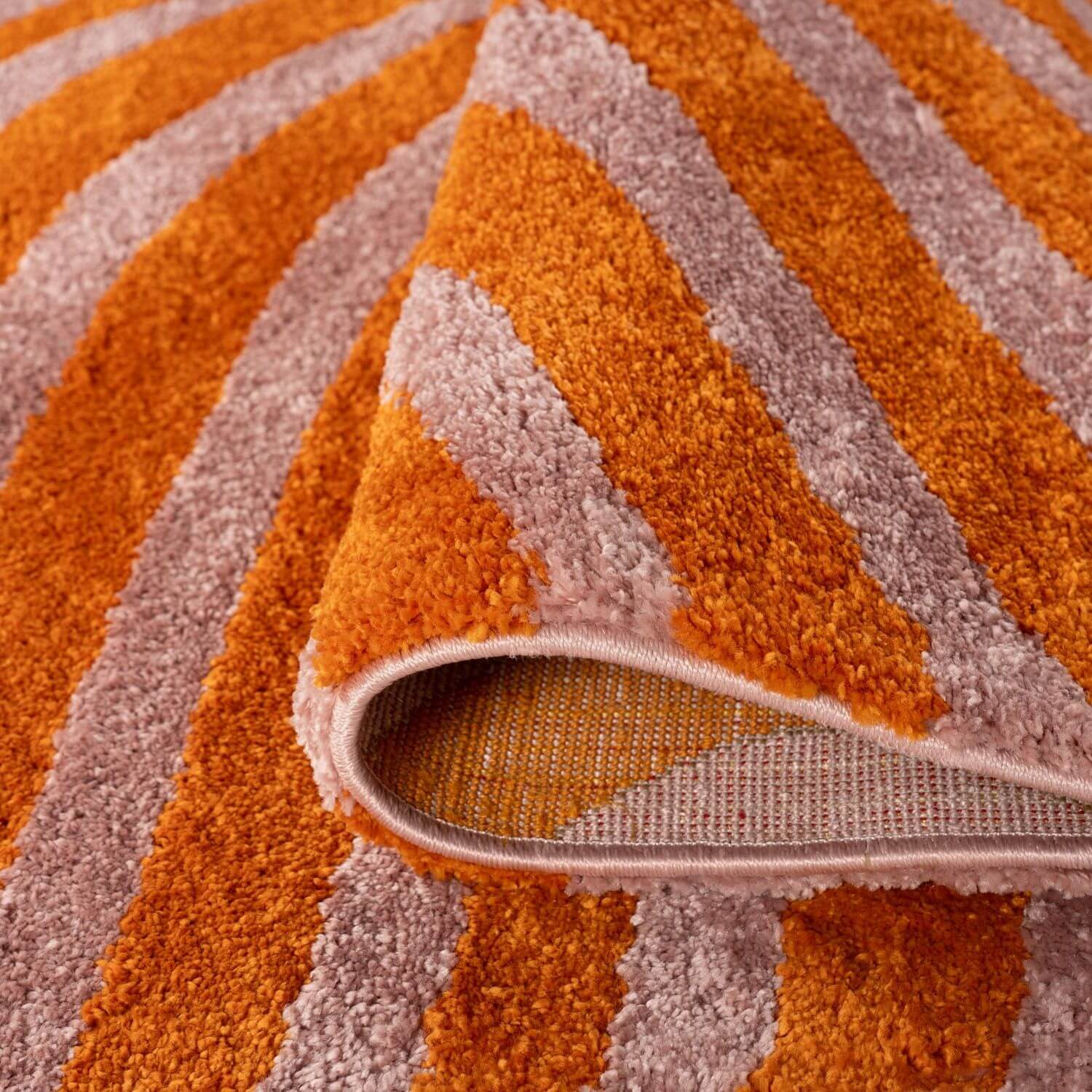Close-up of an orange and pink striped rug