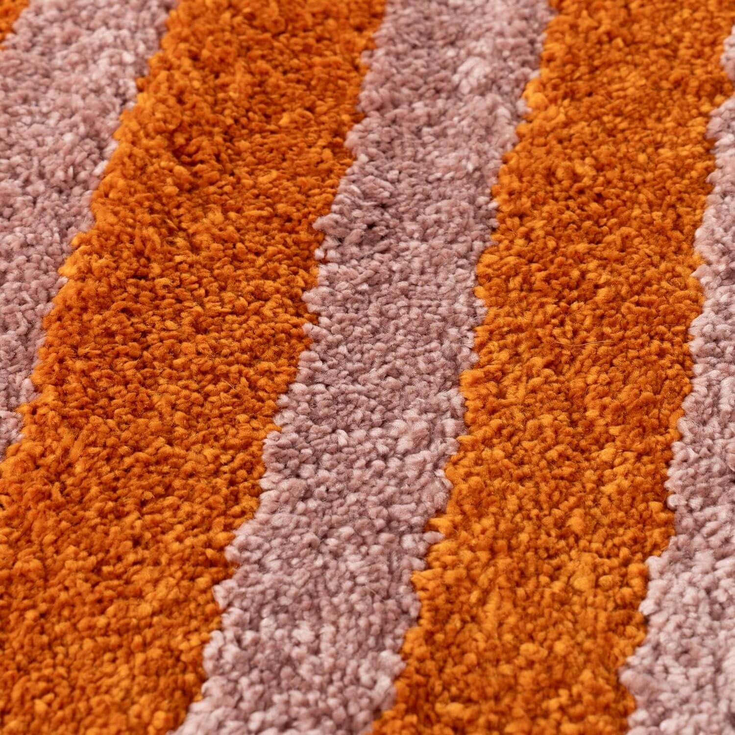 Close-up of a textured orange and pink rug