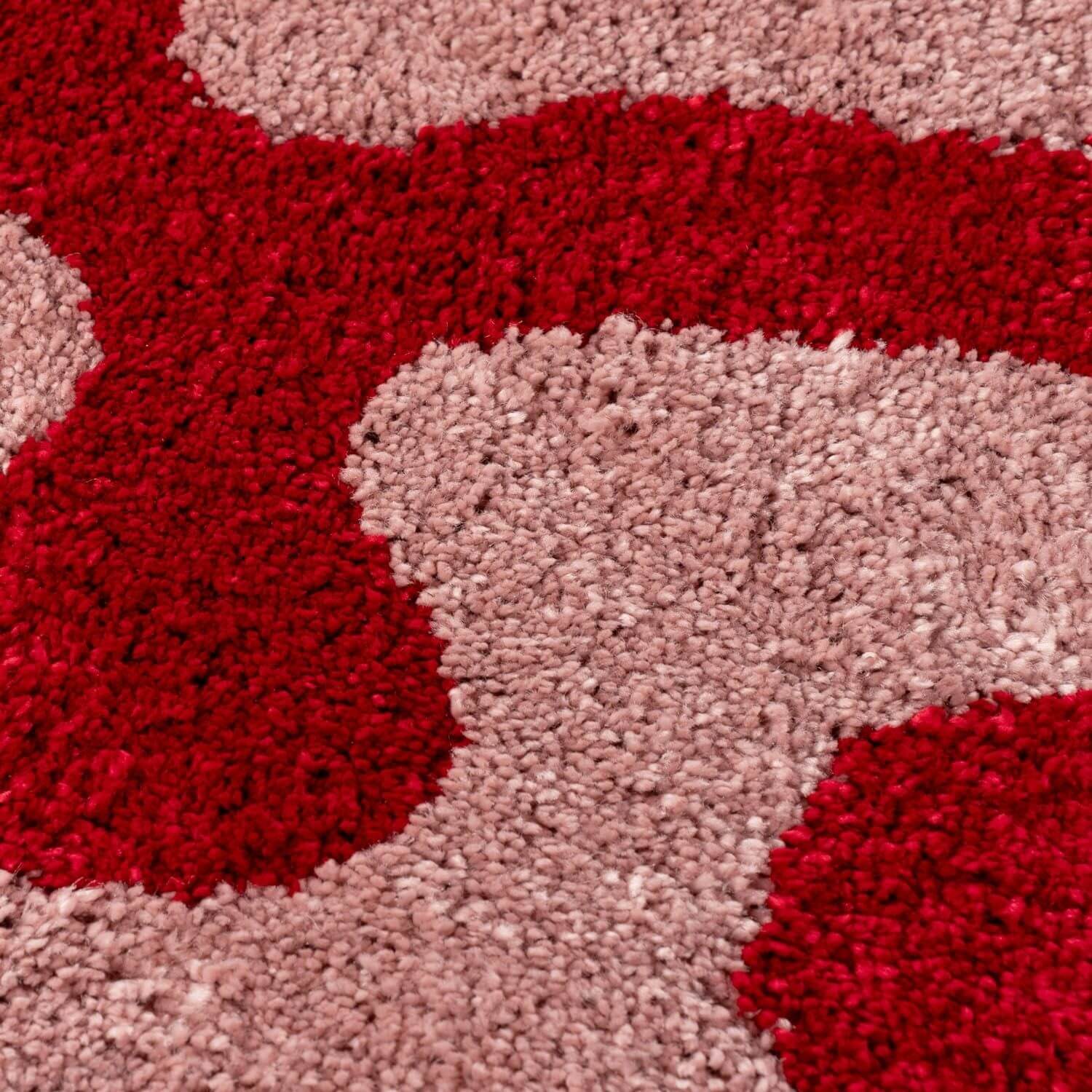 Close-up of a textured red and pink rug
