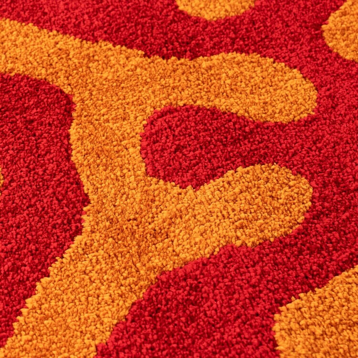 Close-up of a red and orange patterned rug