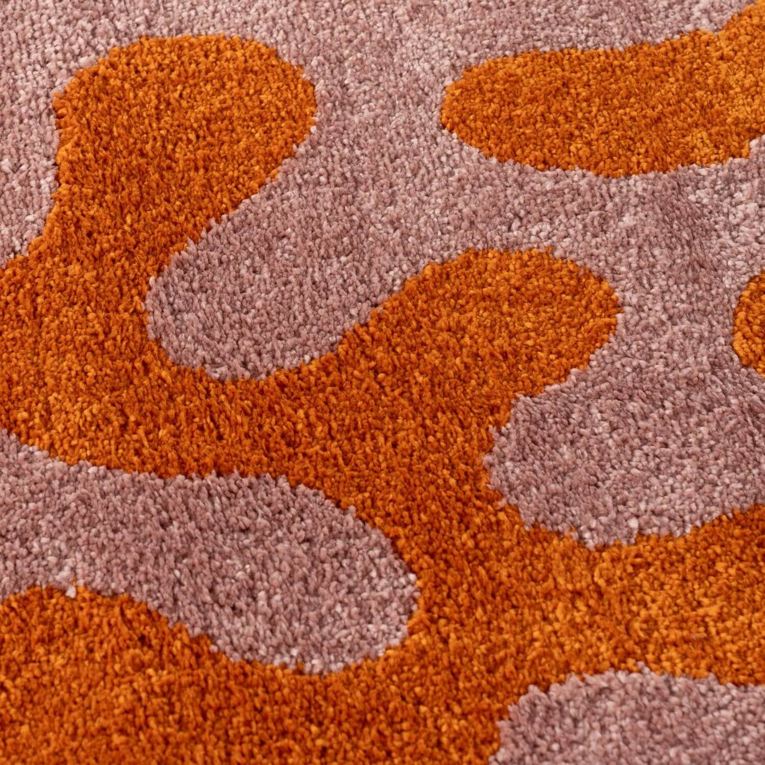 Close-up of a textured orange and pink rug