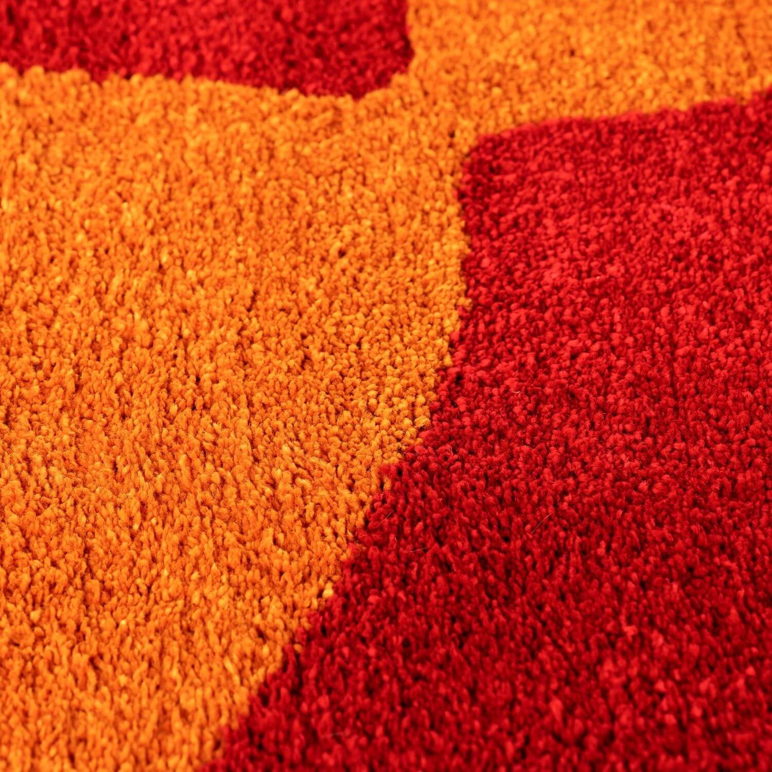 Close-up of red and orange textured rug