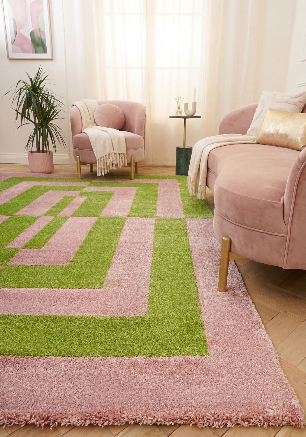 Living room with a pink and green checkered rug, pink armchair, and plant.